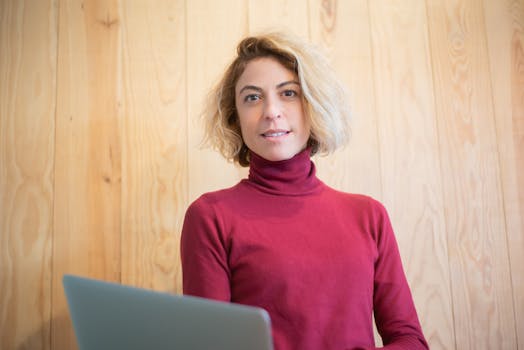 a woman looking at her LinkedIn profile on a laptop