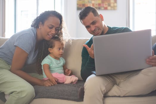 Happy working mom with laptop and child