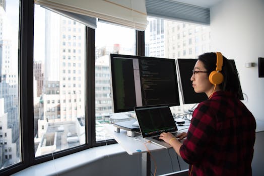 a woman confidently coding at her desk